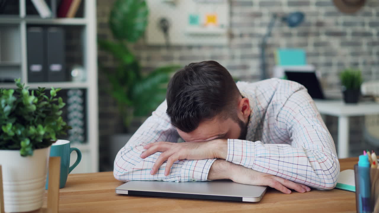 Tired Man Sleeping on Desk