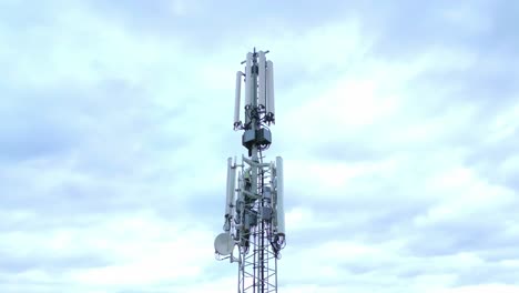 4G-And-5G-Antenna-Of-A-Telecommunication-Tower-Against-Bright-Sky-With-Clouds