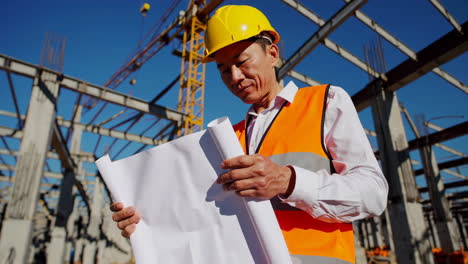 construction engineer reviewing plans on a building site