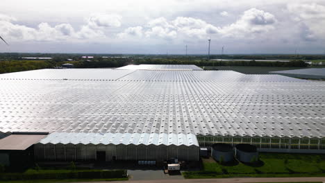 massive industrial greenhouses, aerial drone view