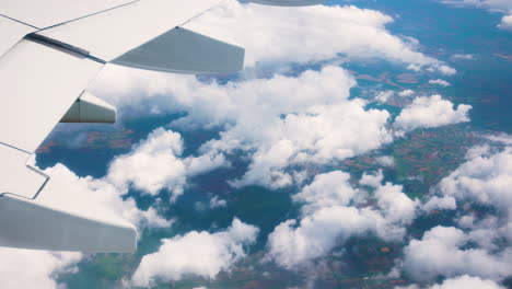 close view of wing of unrecognizable flying airplane, seen from inside