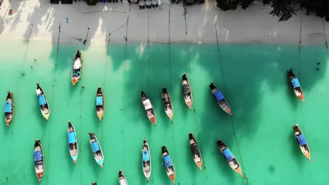 Overhead-aerial-view-of-traditional-long-tail-boats-on-tropical-sea-in-Thailand