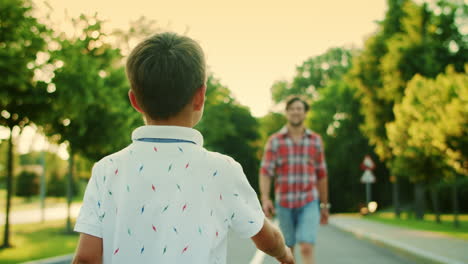 Small-boy-going-on-street.-Handsome-man-and-boy-walking-towards-each-other