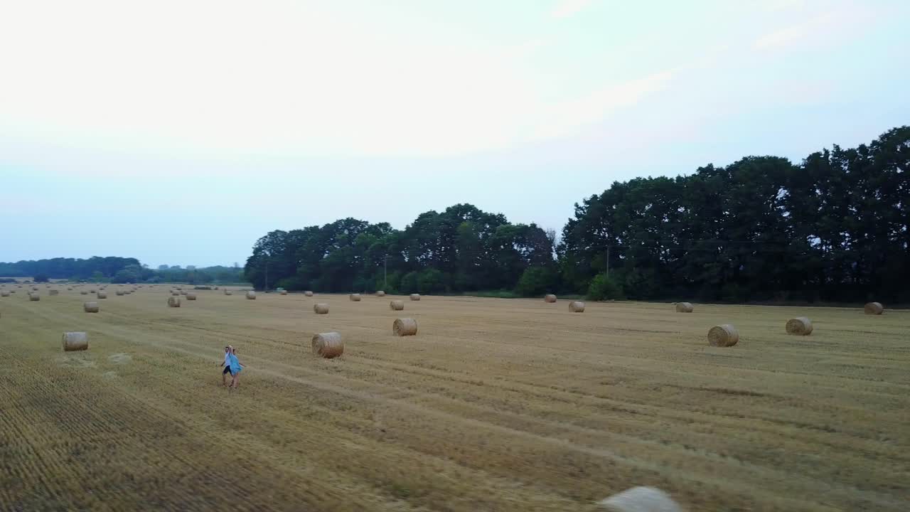 Couple Walking Near Haystack. Young couple walking together near haystack