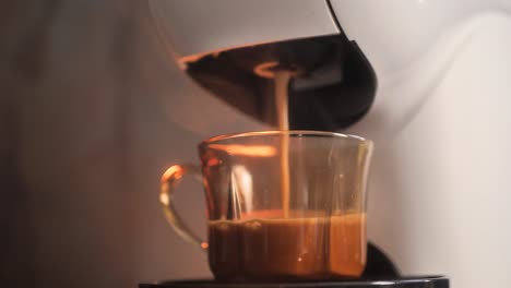 process of making espresso coffee by coffee machine into a glass cup