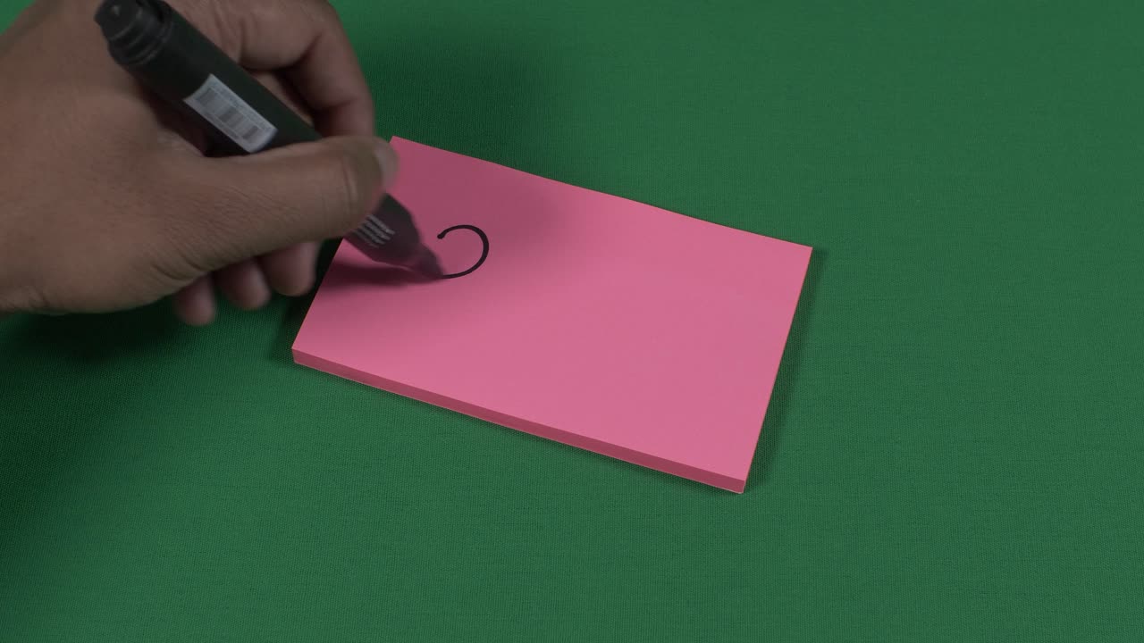 Male Left Hand Writing 2021 On Pink Post It Note