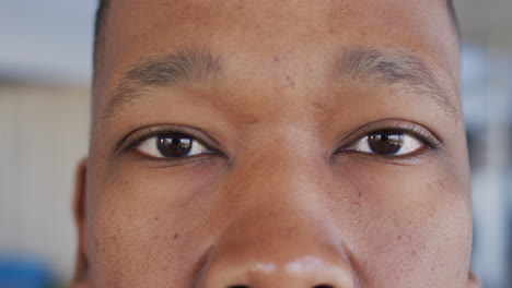 portrait of african american businessman looking at camera and smiling at office, slow motion