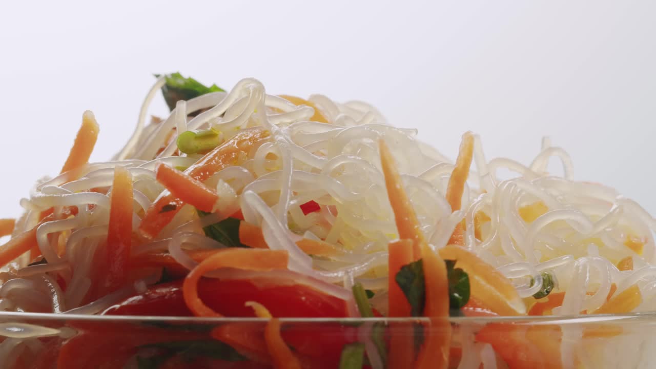 Glass noodles salad with meat and carrots fermented close up asian chinese traditional food.