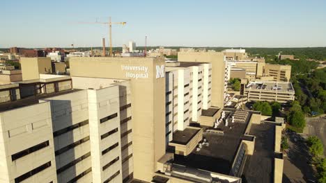 University-of-Michigan-Hospital-logo-and-building,-aerial-drone-view