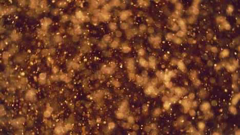 abstract golden particles with blurred defocused bokeh moves chaos, snow flakes