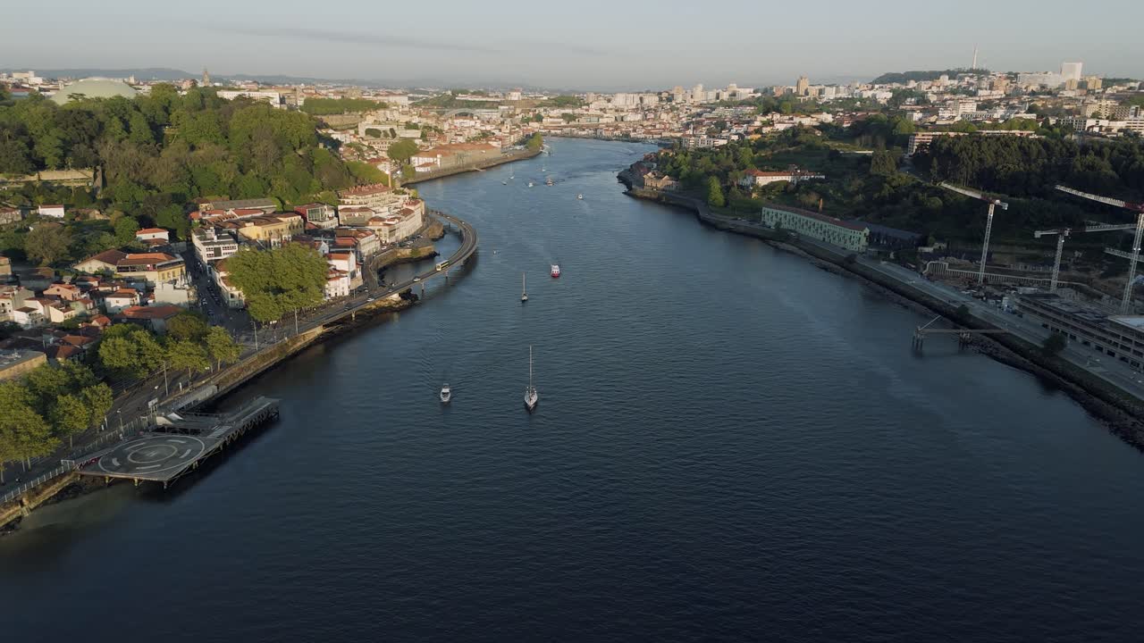 Fly over Douro River, boats, buildings and more spotted. Porto