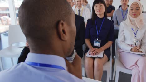 male speaker addressing the audience at a business seminar