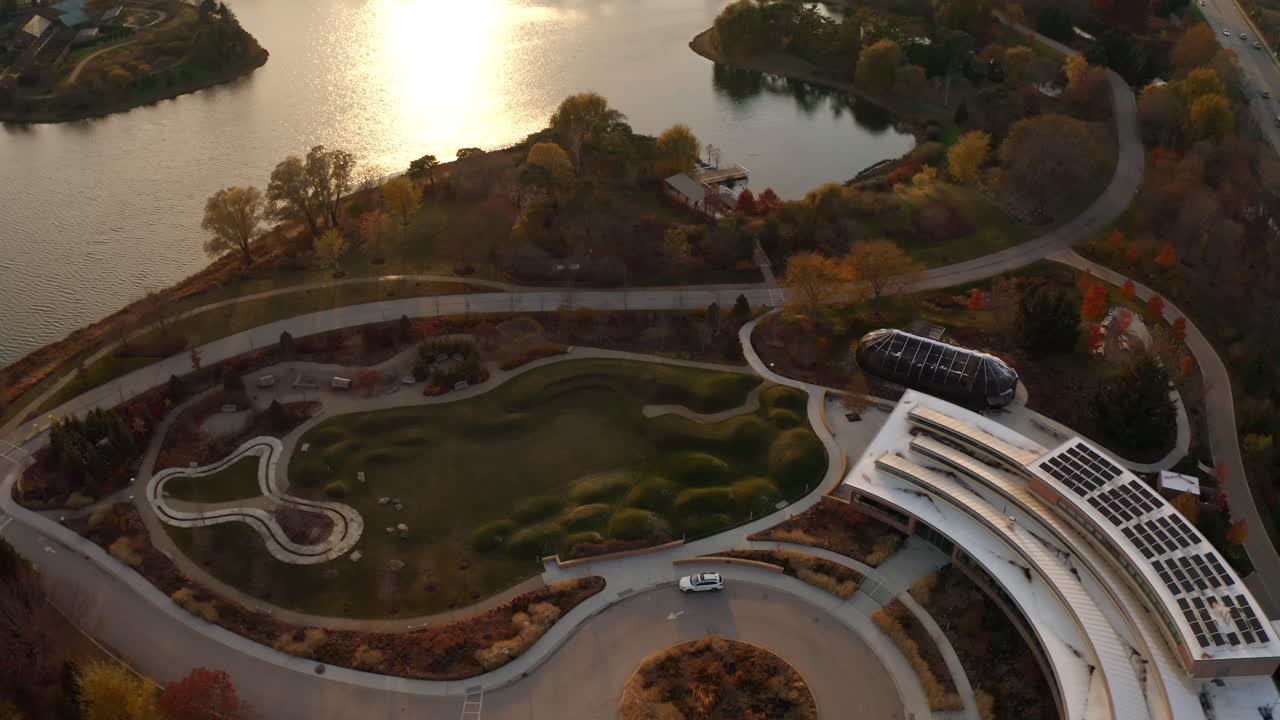 Glencoe, Illinois, USA: Luftaufnahme mit Drohne über die Architektur von Gebäuden im Chicago Botanic Garden an einem See am Abend.