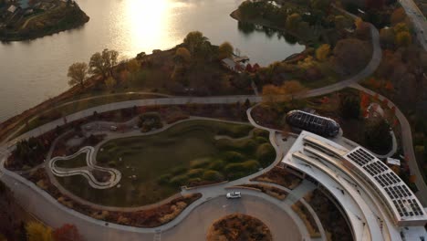 glencoe, illinois, usa :aerial drone shot over building architecture in chicago botanic garden alongside a lake during evening time