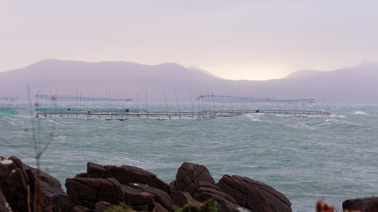 Salmon aquafarm with stocked marine fish pens in choppy waters of Sound of Mull