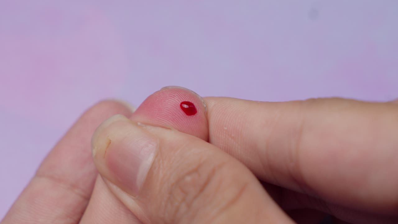 Poking their finger to obtain a blood sample