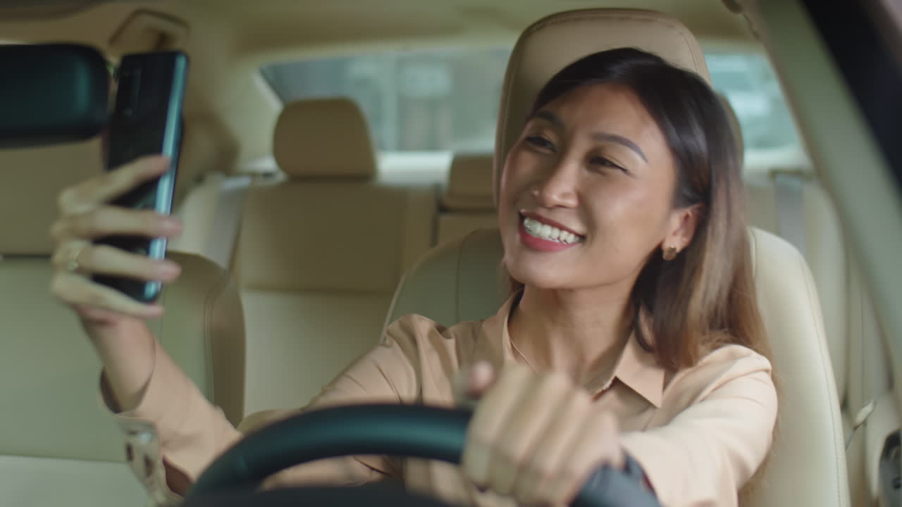 Asian Businesswoman Video Calling in Car
