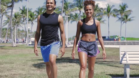 Smiling-couple-exercising-with-legs-up