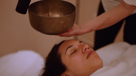 soul bending tibetan singing bowl next to sleeping massage customer