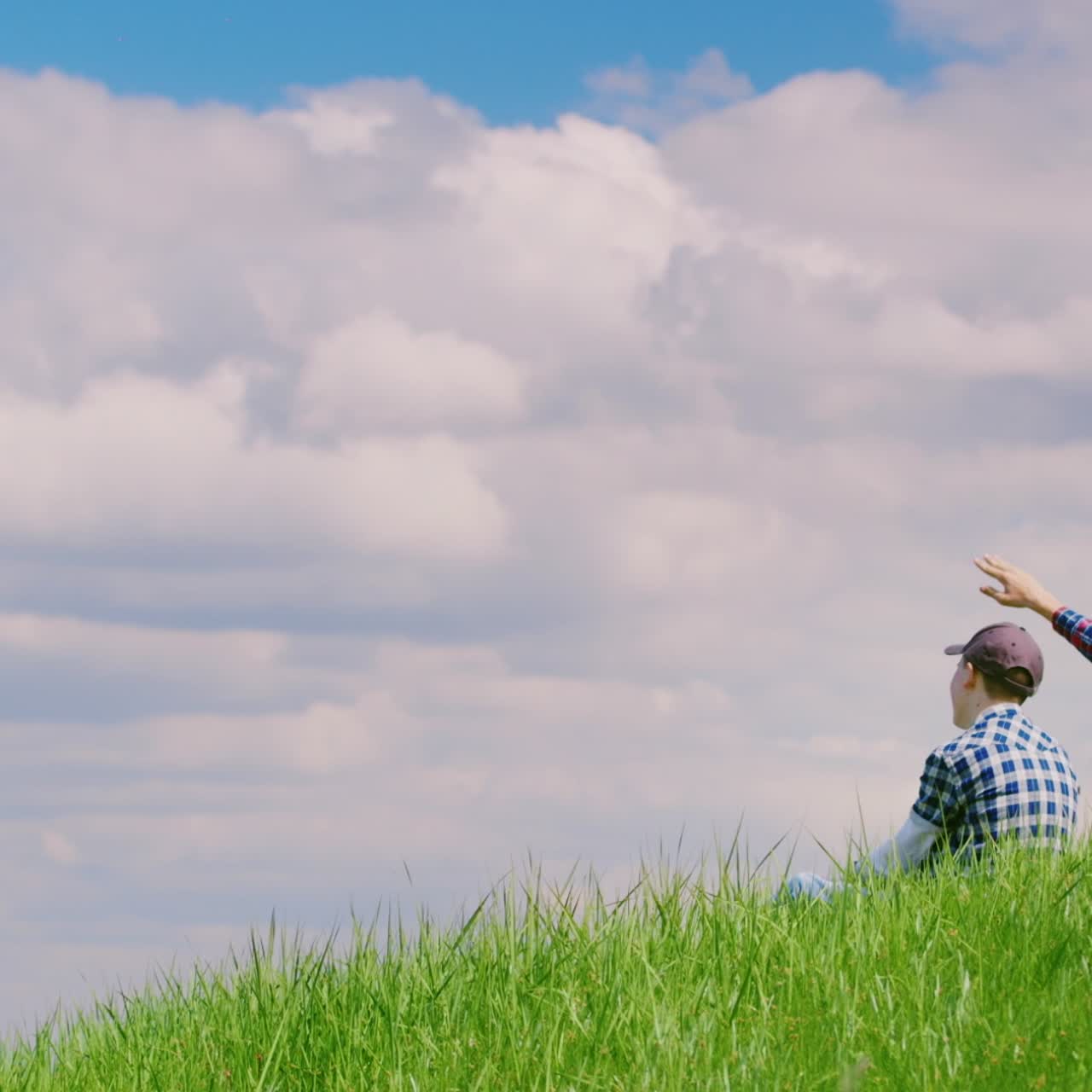 Two Teenage Boys Are Sitting On A Green Meadow Using Mobile Phones Free  Stock Video Footage Download Clips Technology