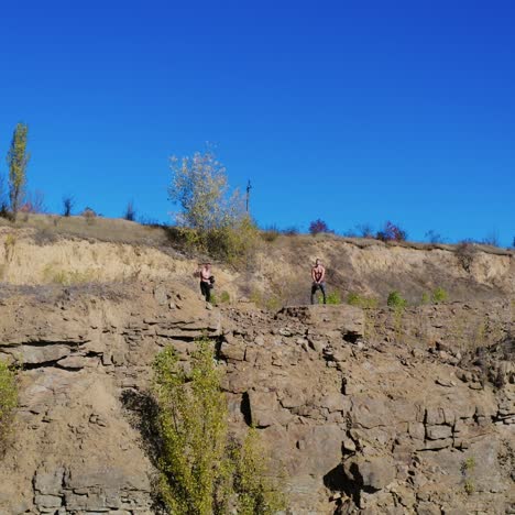 . athletes exercising with dumbbells. male young athlete in nature with dumbbells