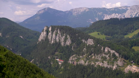 freighter train passing at railway through stunning mountain landscape in austria