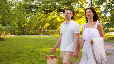 Feliz-Pareja-Haciendo-Un-Picnic-En-El-Parque-De-Verano.-Concepto-De-Ocio-Y-Personas.-Feliz-Pareja-Con-Comida-Haciendo-Un-Picnic-En-El-Parque-De-Verano.