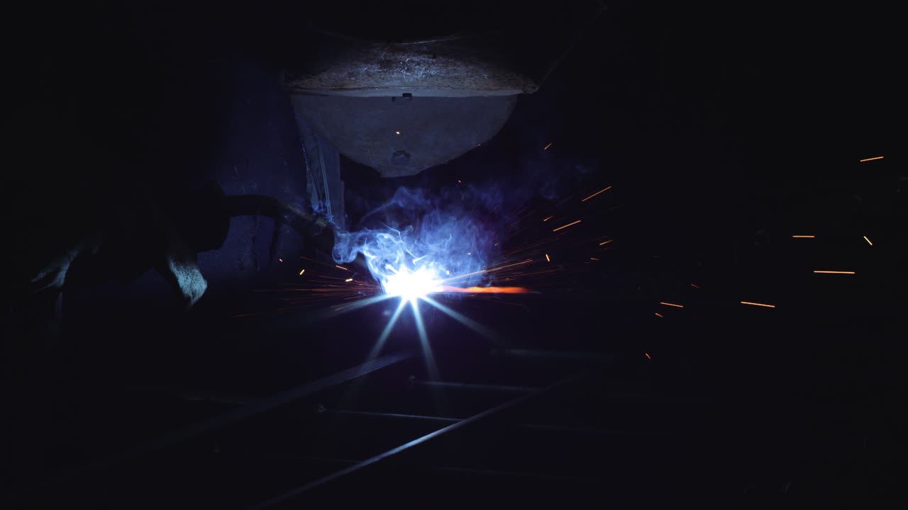 Welder at Work: Sparks Fly in the Night