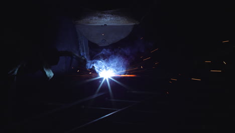 welder at work: sparks fly in the night