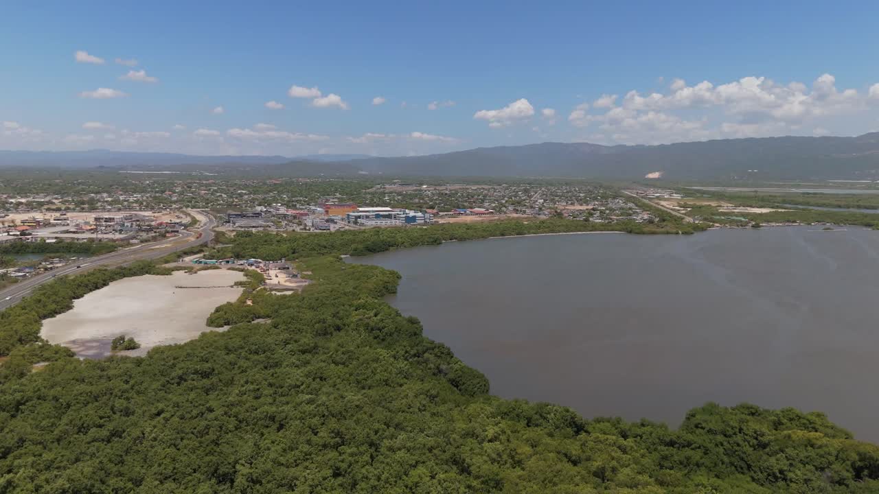 Aerial view of Portmore, Jamaica, highlighting cityscapes, residential areas,