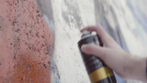 graffiti artist spray painting a wall