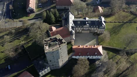 drone aerial view of the fairytale castle adelebsen on a beautiful autmn afternoon in golden sunlight