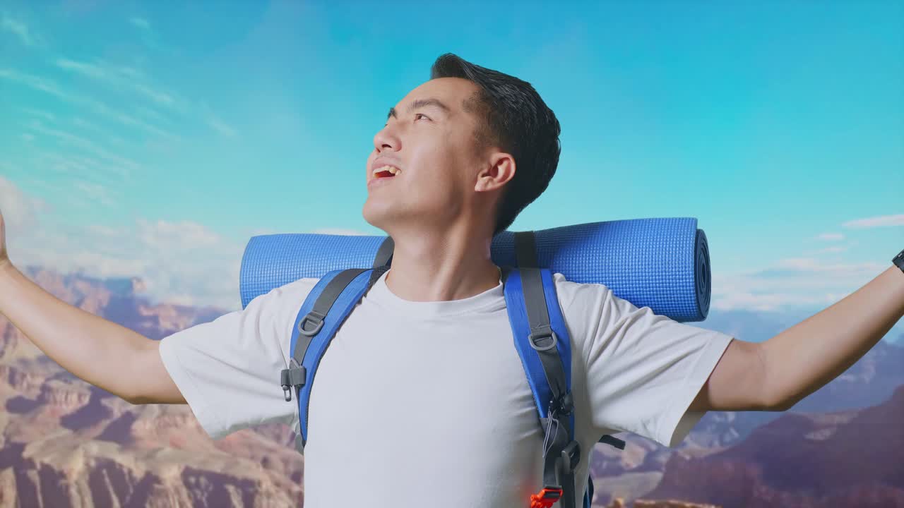Close Up Of Asian Male Hiker With Mountaineering Backpack Smiling And Spreading Arms Enjoy Looking The View Around While Traveling At The Top Of Mountain