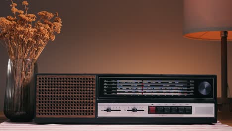 old retro am fm radio with tubes, hand changing stations , bulb vintage music player.