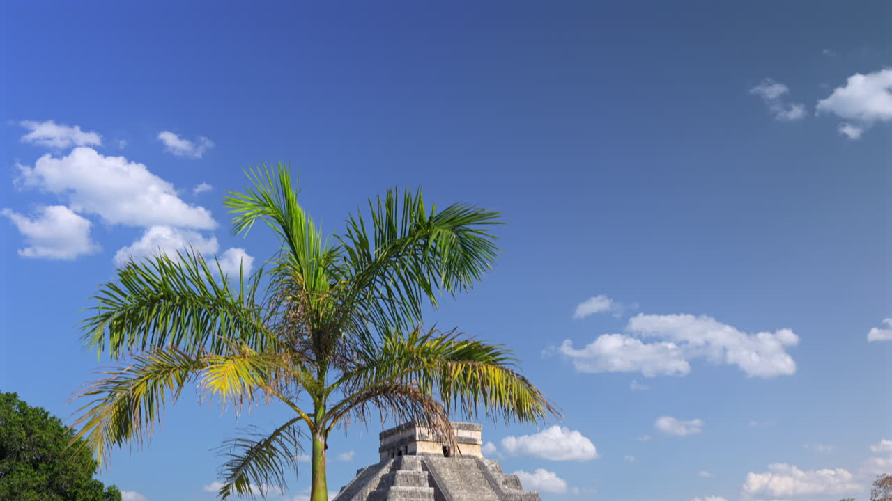 Tourists visiting step pyramid in Chichen Itza, ancient ruins