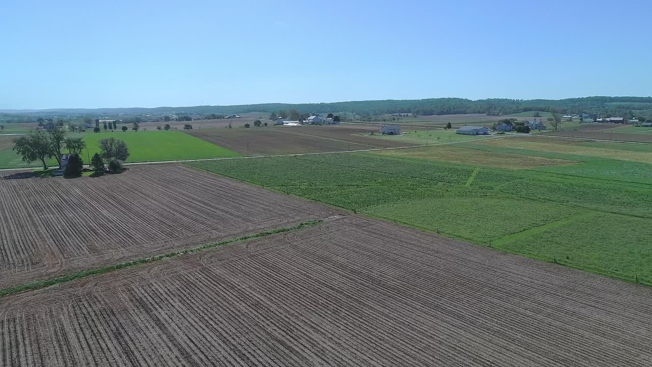 A Drone Moving Slowly Panasonic View of Amish Countryside, Plowed and Fields Growing, Cows Grazing, on a Sunny Spring Day