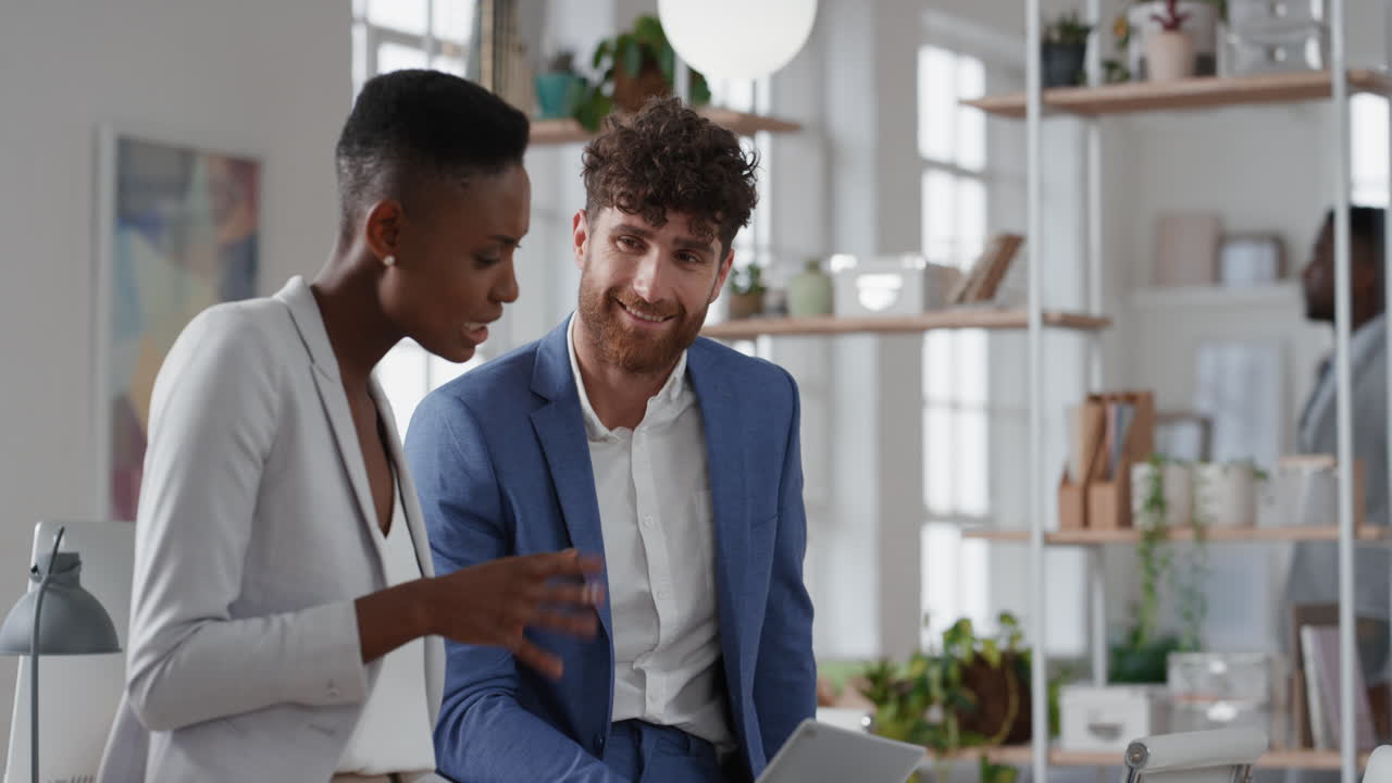 african american business woman team leader brainstorming with colleague using laptop computer showing ideas pointing at screen working together in office