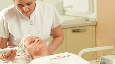 woman getting anti-aging therapy at beauty treatment salon