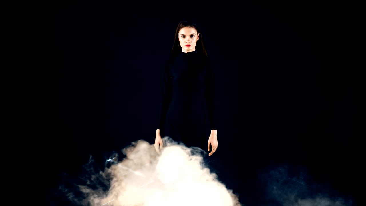 Stylish fashion girl futuristic technology black background cinematic lighting with smoke and backlight effect.Prores
