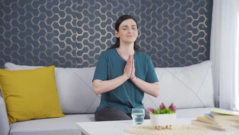 Christian-woman-praying-in-front-of-the-window.