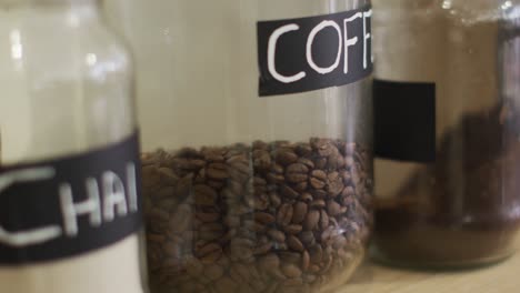 video of jars with diverse type of coffee standing on shelf at coffee shop