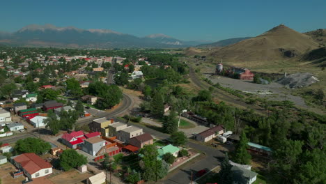 Aerial-cinematic-drone-mid-summer-downtown-Salida-S-Colorado-near-Buena-Vista-on-Arkansas-River-Riverside-Park-Scout-surfing-wave-mountain-biking-hiking-rafting-Rocky-Mountain-down-movement