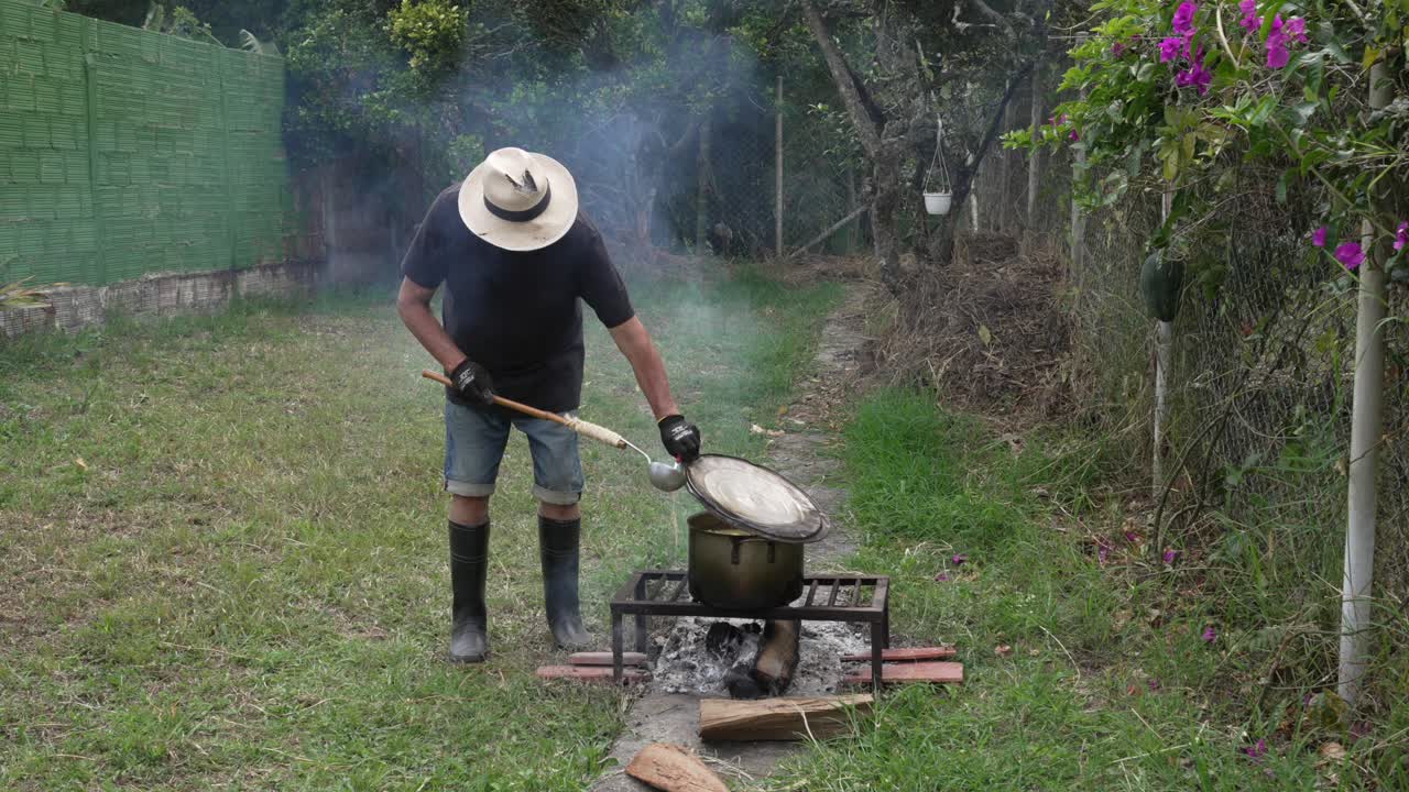 Outdoor cooking authentic Colombian cuisine, pot simmer over open wood fire