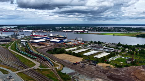 industrial port with cargo handling and storage facility in riga, latvia. aerial drone shot