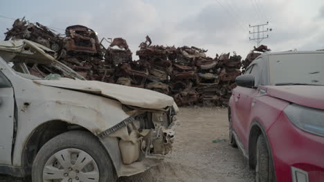 wall of cars in the burnt vehicle lot memorial, tkuma israel after hamas attack