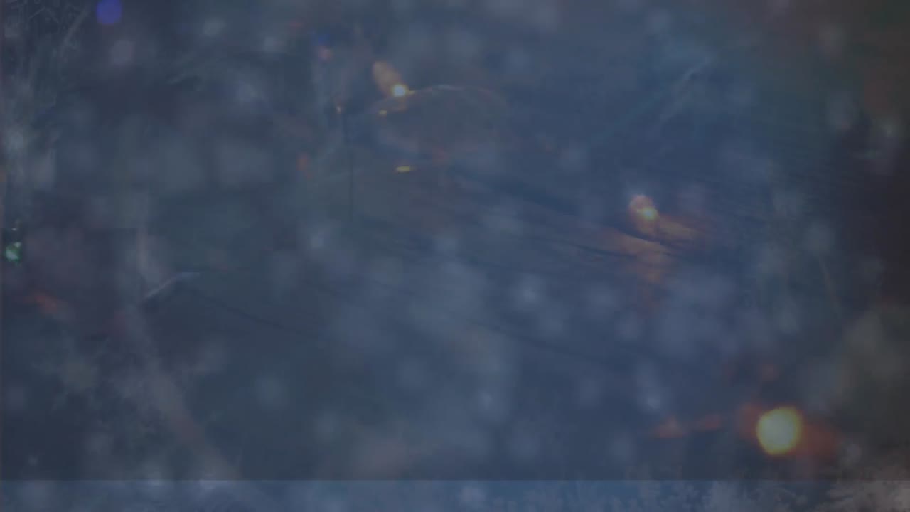 Animation of snow falling over blurred lights on blue background