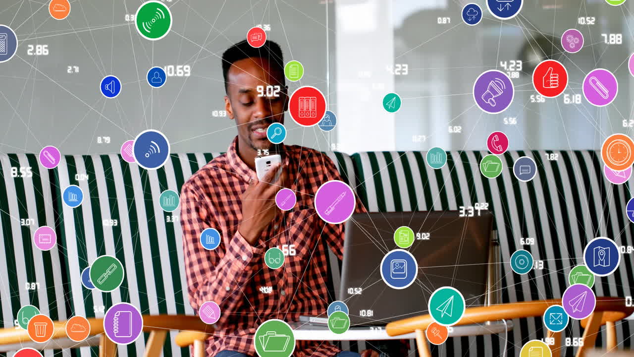 Animation of connected icons with numbers over african american man talking on speaker of cellphone