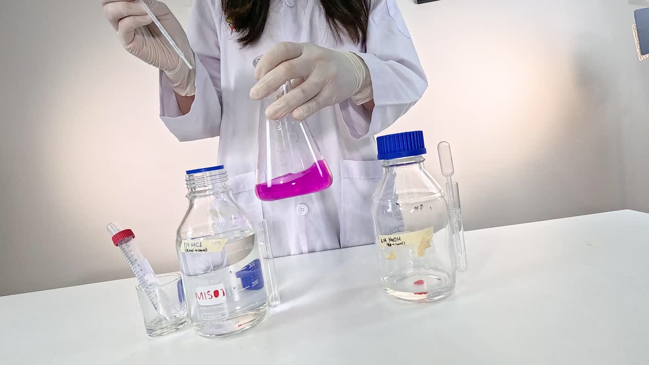 el científico lleva a cabo una reacción química con una solución púrpura