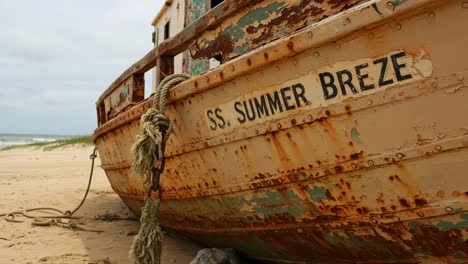 the rusted remains of the ss summer breeze: a weathered shipwreck on the shoreline, capturing the essence of time and nature’s relentless erosion