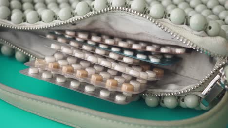 birth control pills in a beaded purse